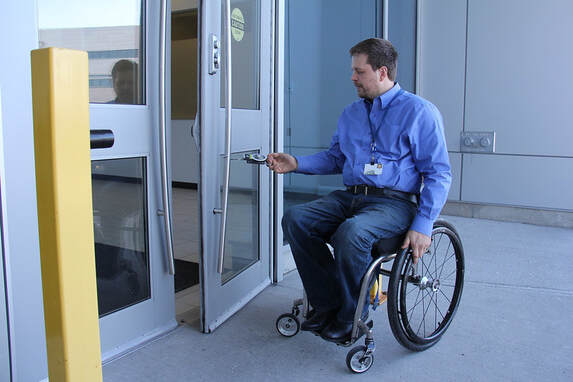 Man using wheelchair assessing accessibility