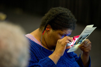 Black woman using hearing and seeing assist devices